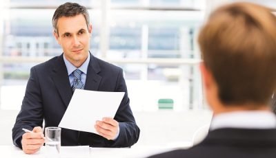 businessman interviewing male candidate